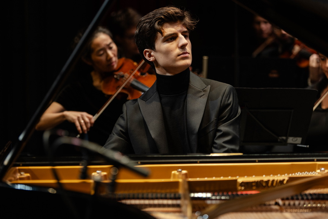 Portrait of pianist Giorgio Agnès at a Steinway grand piano